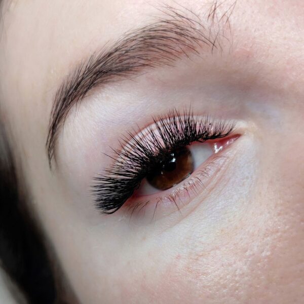 Close-up of a woman's eye with long lashes.