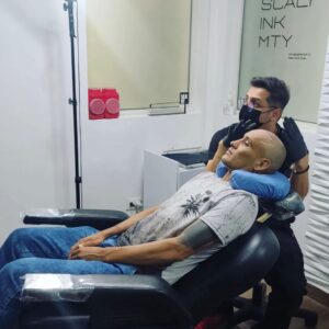 Man receiving scalp micropigmentation treatment.