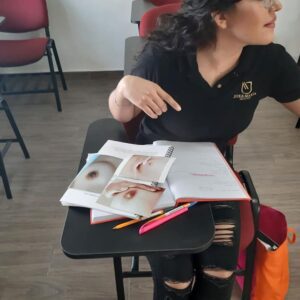 Woman studying skin anatomy in class.