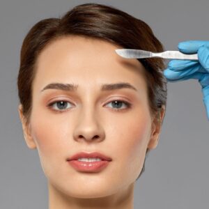 Woman with scalpel on her forehead.