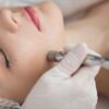 Close-up of a woman receiving a facial.