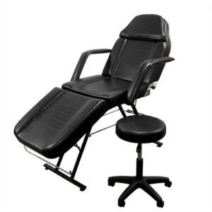 Black adjustable salon chair with stool.