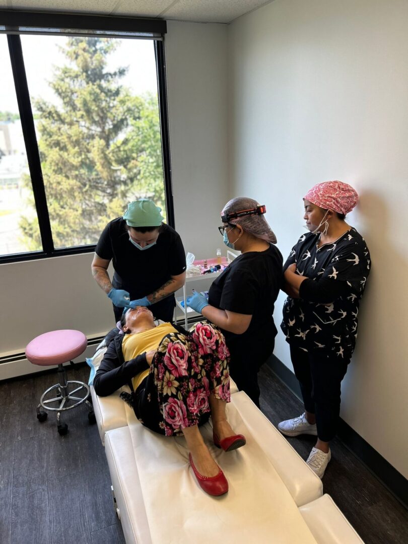 Three women receiving medical treatment.