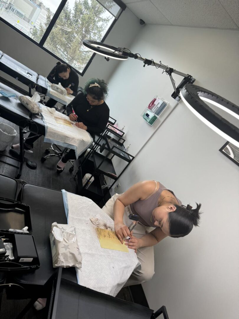 Three women practicing makeup artistry.