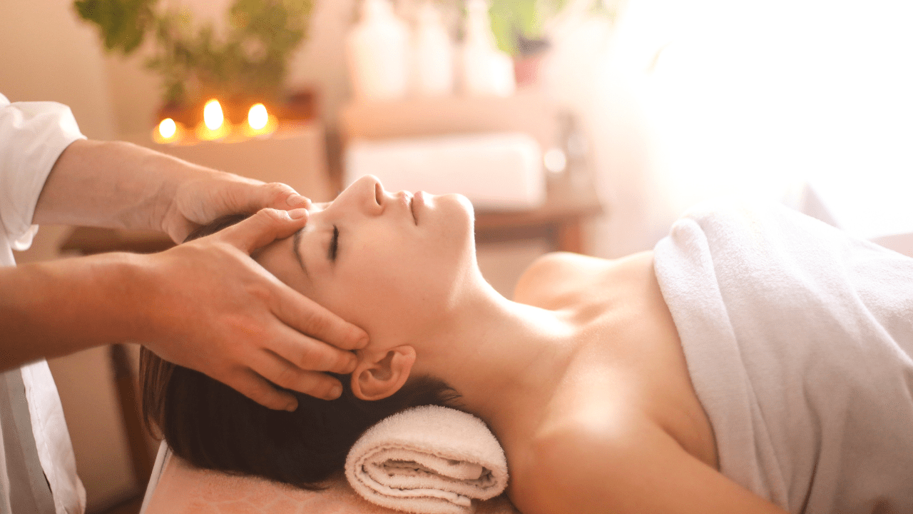 Woman receiving a relaxing facial massage.